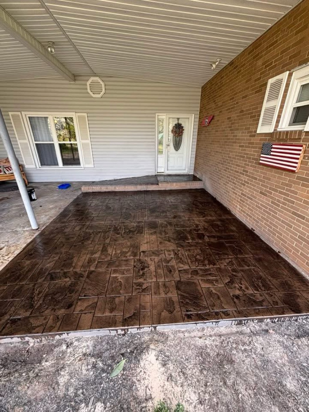 Stamped concrete patio at a brick home