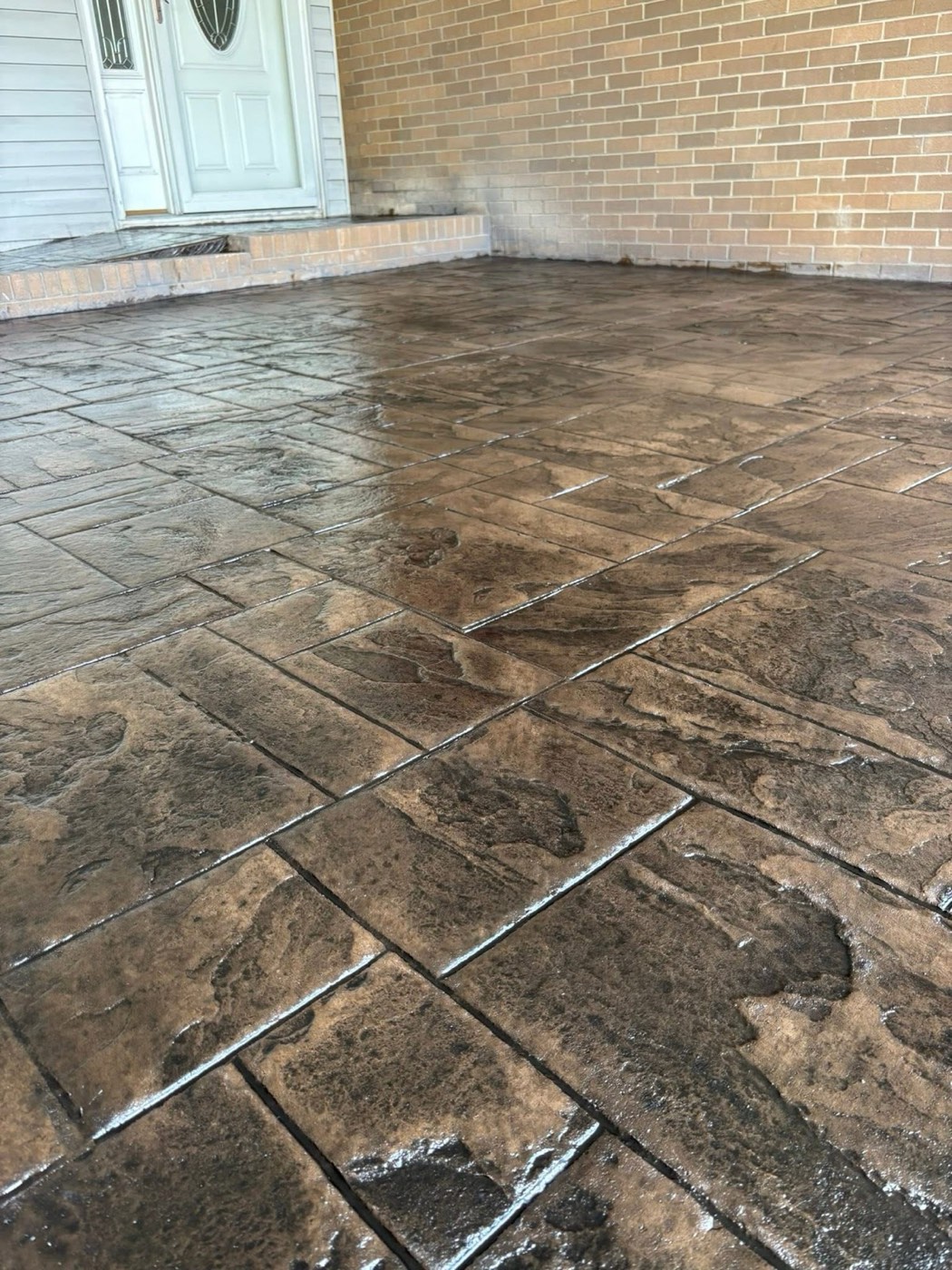 Tan ashlar-slate stamped patio