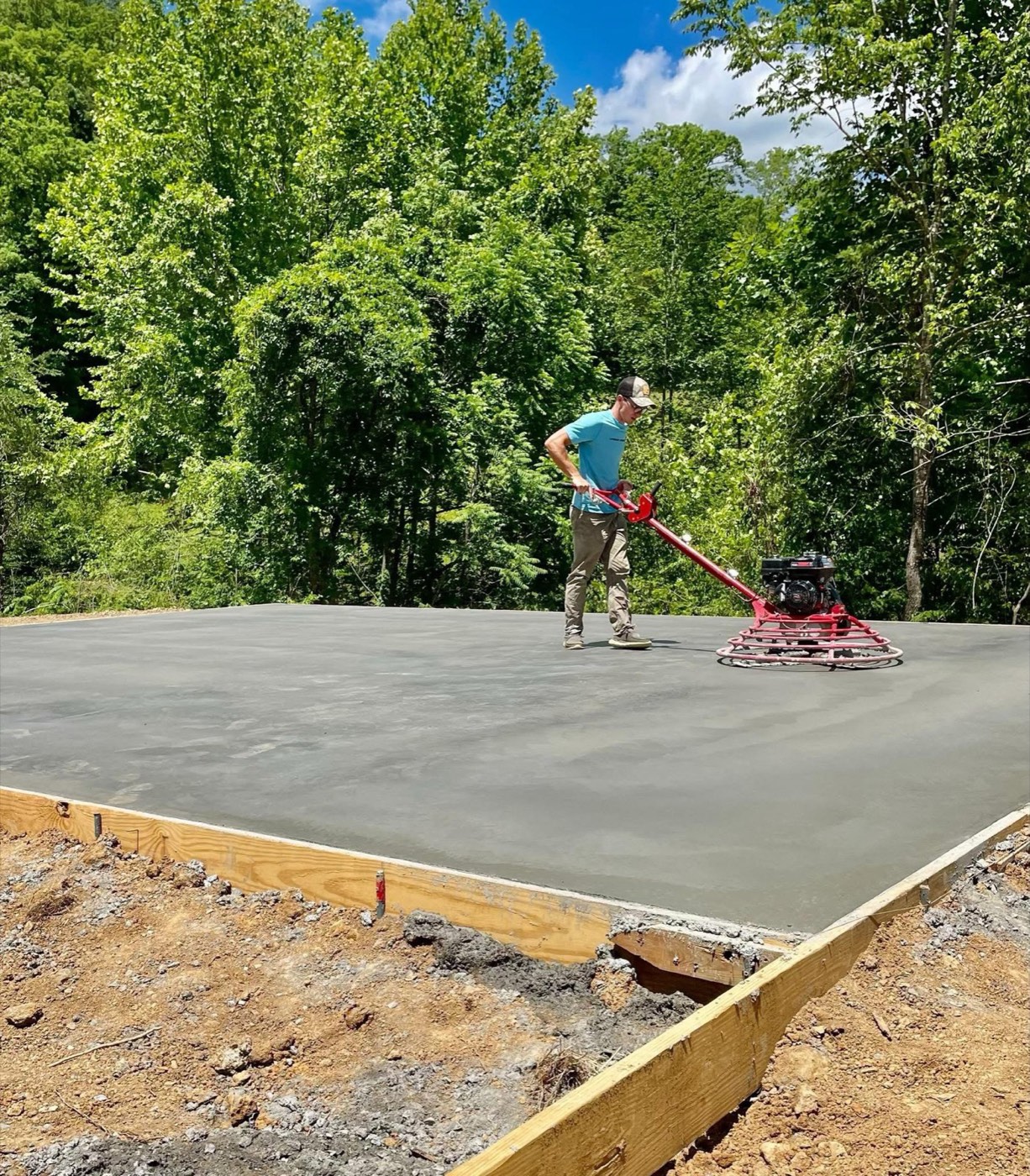 Stamped concrete walkway around a stone home