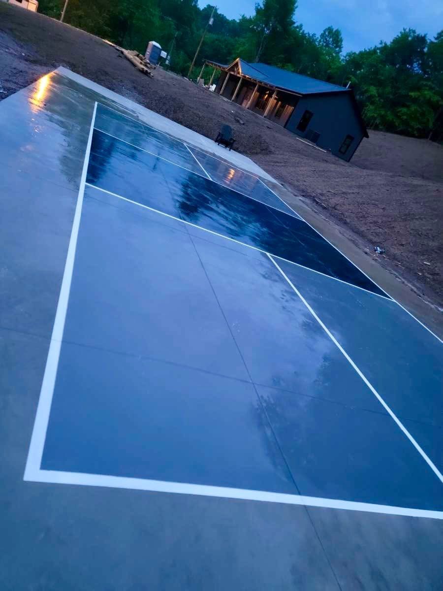 Stamped concrete pickleball court at dusk