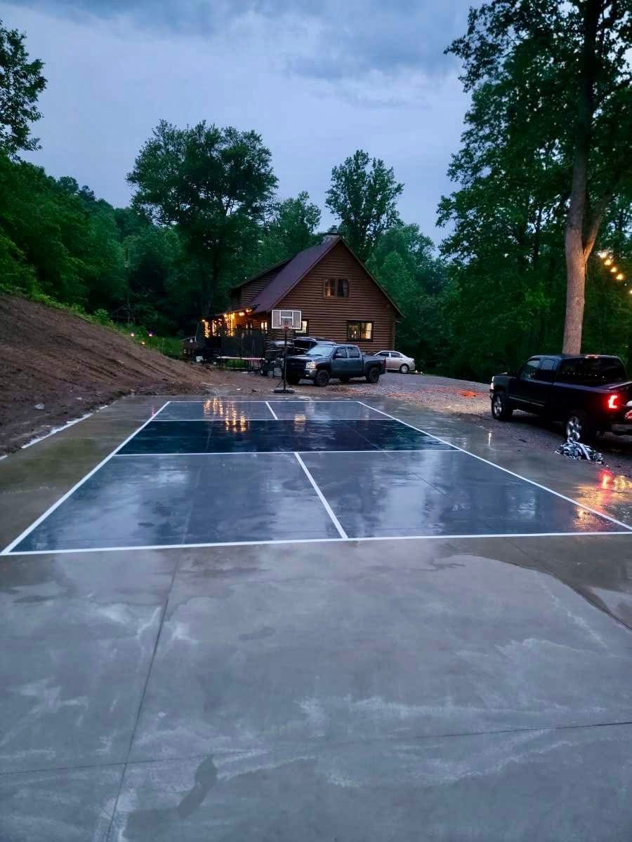 Multi-game sport court with basketball hoop